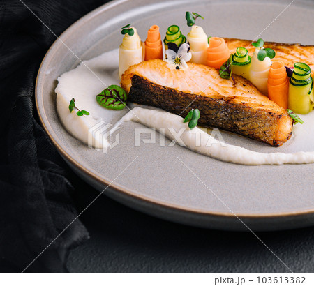 Salmon fish steak grilled and fresh beautifully decorated vegetables Salmon fish steak grilled and fresh beautifully decorated vegetables 103613382