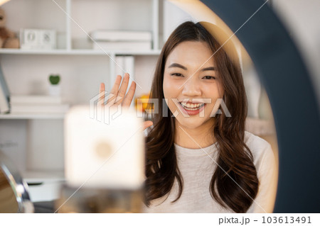 Woman with a social media influence is greeting the audience for recording vlog video live streaming, Showing how to make up and use cosmetics, Online business on concept of beauty bloggers. Woman with a social media influence is greeting the audience for recording vlog video live streaming, Showing how to make up and use cosmetics, Online business on concept of beauty bloggers. 103613491