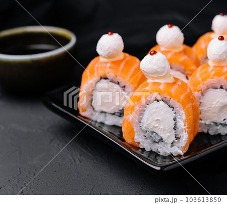 Salmon sushi with rice on black plate 103613850