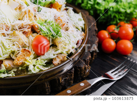 Fresh Caesar Salad on a Wooden Kitchen Table Fresh Caesar Salad on a Wooden Kitchen Table 103613875
