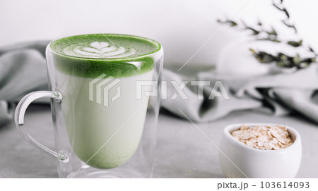 glass cup of fresh matcha latte and oatmeal 103614093