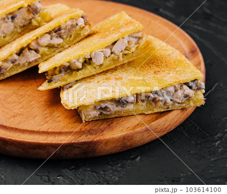 chicken, mushroom and cheese Quesadilla on wooden board 103614100