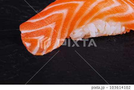 Salmon nigiri sushi on black stone 103614102