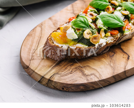 bruschetta with pesto, hazelnuts, cheese and basil bruschetta with pesto, hazelnuts, cheese and basil 103614283