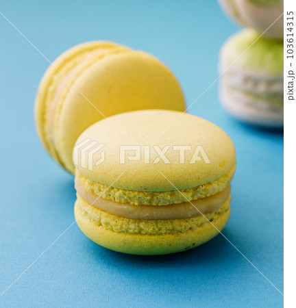 Sweet and colorful macaroons on blue background 103614315