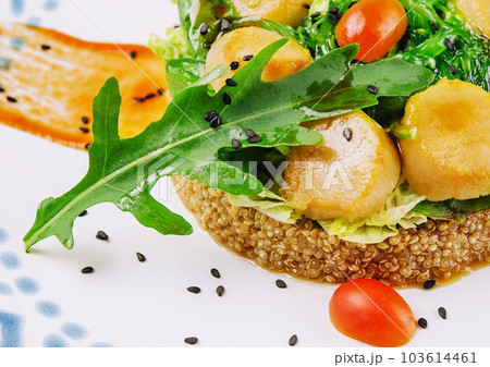Scallops and Couscous with seaweed and arugula 103614461