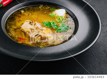 Chicken noodle soup in black plate 103614463