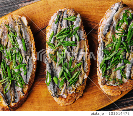 Top view pickled anchovies with spring onions 103614472