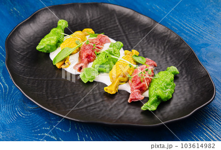 Chinese colourful steamed dumplings on black plate Chinese colourful steamed dumplings on black plate 103614982
