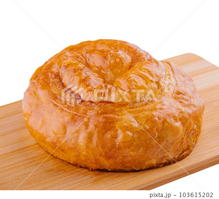 Fresh twisted bun on wooden board Fresh twisted bun on wooden board 103615202