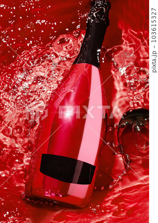 red champagne bottle and glass in water 103615327