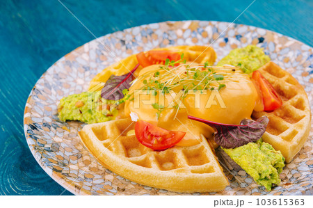 belgian waffles with poached egg and avocado 103615363