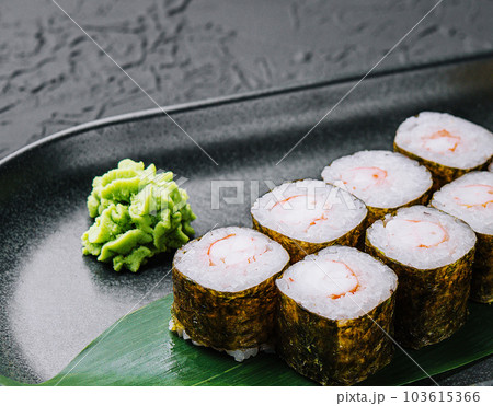 Traditional fresh japanese sushi maki on black stone plate Traditional fresh japanese sushi maki on black stone plate 103615366