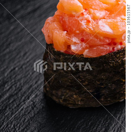 Gunkan with salmon on black wood background Gunkan with salmon on black wood background 103615567