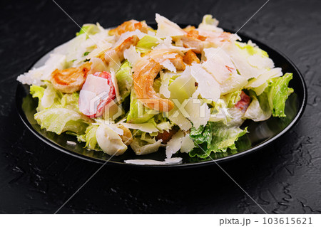 Delicious fresh caesar salad on black plate 103615621