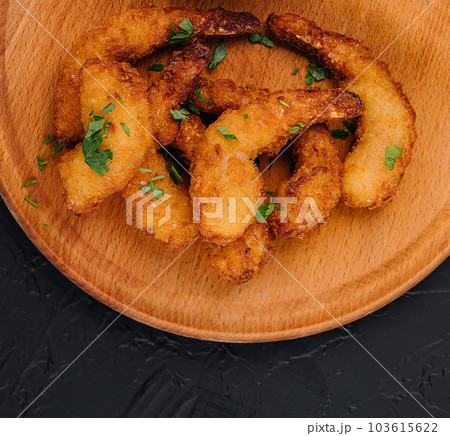 Fried shrimps or prawns with sauce on board Fried shrimps or prawns with sauce on board 103615622
