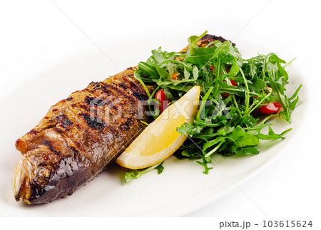 Grilled sea bream fish, lemon, arugula on white plate 103615624