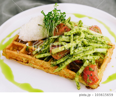 Closeup of tasty vegan potato waffle with pesto and fresh natural vegetables 103615659