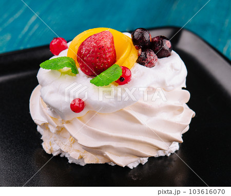 Anna Pavlova cake with cream and fresh berries Anna Pavlova cake with cream and fresh berries 103616070