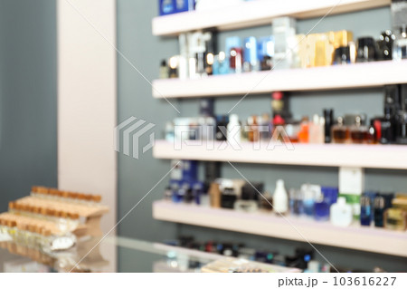 Blurred view of shelves with perfume bottles in shop 103616227