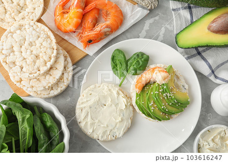 Puffed rice cake with shrimp and avocado served on grey marble table, flat lay 103616247