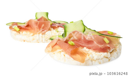 Puffed rice cakes with prosciutto and cucumber isolated on white 103616248