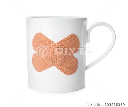Cup with sticking plasters isolated on white 103616339
