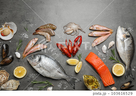 Fresh fish and seafood on grey table, flat lay 103616529