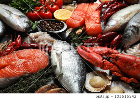 Fresh fish and different seafood on table, closeup 103616542
