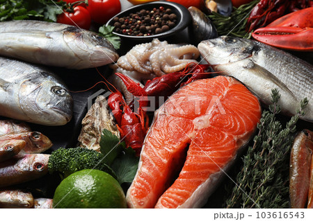 Fresh fish and different seafood on table, closeup 103616543
