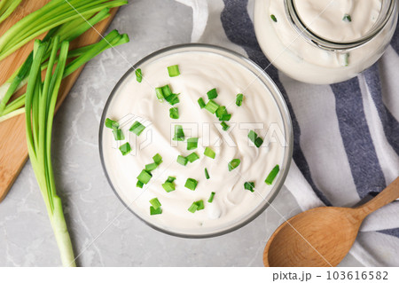 Fresh sour cream with onion on grey marble table, flat lay Fresh sour cream with onion on grey marble table, flat lay 103616582