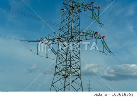 High voltage towers with sky background. Power line support with wires for electricity transmission. High voltage grid tower with wire cable at distribution station. Energy industry, energy saving 103616958