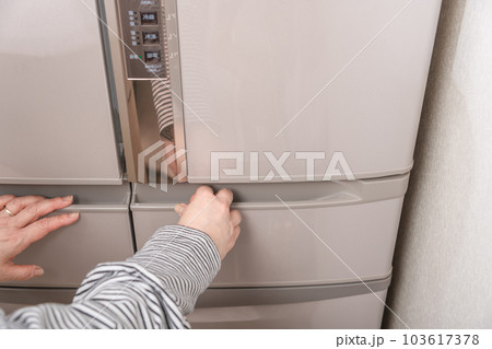 【冷凍室を開ける主婦】 103617378