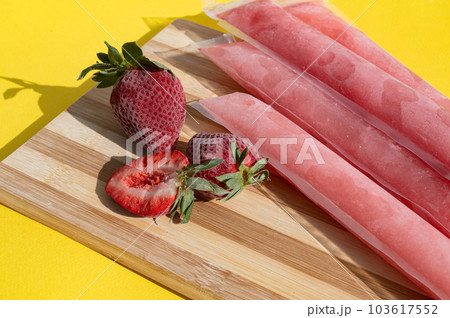 Ice cream in a bag with strawberries, sweet frozen homemade. Brazilian Dindin, chup-chup Ice cream in a bag with strawberries, sweet frozen homemade. Brazilian Dindin, chup-chup 103617552