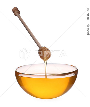 Honey dripping from wooden dipper into bowl isolated on white 103618192