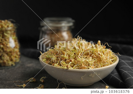 Bowl of sprouted green buckwheat on grey table, closeup 103618376