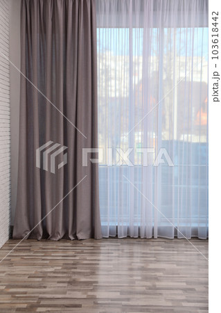 Window with elegant curtains in empty room 103618442