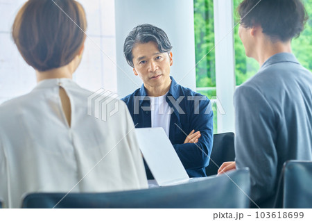 オフィスで打ち合わせする男女のビジネスチーム 103618699