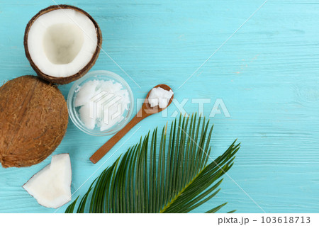 Flat lay composition with organic coconut oil on light blue wooden table. Healthy cooking 103618713
