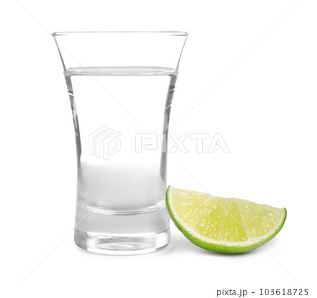 Mexican Tequila shot with lime slice isolated on white Mexican Tequila shot with lime slice isolated on white 103618725