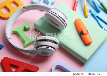 Book, headphones and stationery on color background 103618752