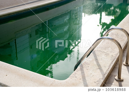 Swimming pool with dirty green water close-up. Swimming pool with dirty green water close-up. 103618988