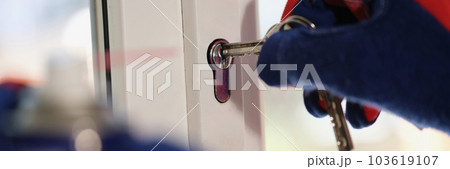 Repairman checking keys and lock of plastic window Repairman checking keys and lock of plastic window 103619107