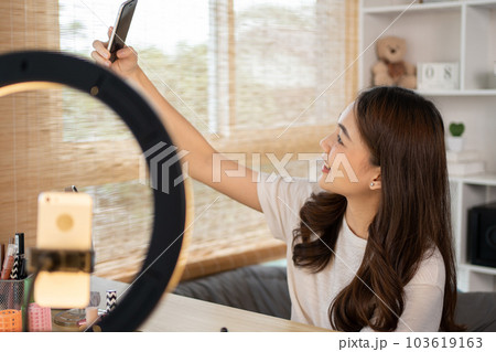 Beautiful woman with a social media influence is greeting the audience for recording vlog video live streaming, Showing how to make up and use cosmetics, Online business on concept of beauty bloggers. 103619163
