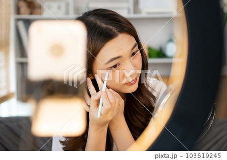 Beautiful women with social media influences are teaching makeup and use cosmetics, In front of the camera to recording vlog video live streaming, Online business on concept of beauty bloggers. Beautiful women with social media influences are teaching makeup and use cosmetics, In front of the camera to recording vlog video live streaming, Online business on concept of beauty bloggers. 103619245