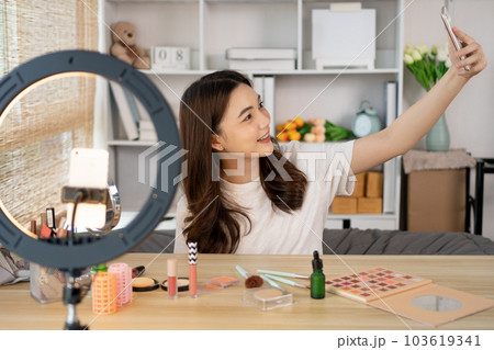 Beautiful woman with a social media influence is greeting the audience for recording vlog video live streaming, Showing how to make up and use cosmetics, Online business on concept of beauty bloggers. 103619341