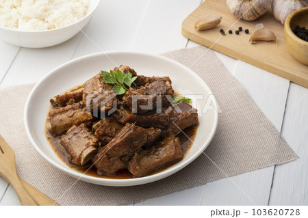 Braised pork spare ribs with soy sauce in white plate Braised pork spare ribs with soy sauce in white plate 103620728