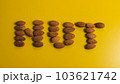 Inscription nut from almond grains on a yellow background 103621742