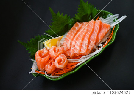 fresh raw salmon fish for cooking food seafood salmon fish, salmon sashimi food salmon fillet japanese menu with shiso perilla leaf lemon herb and spices 103624627