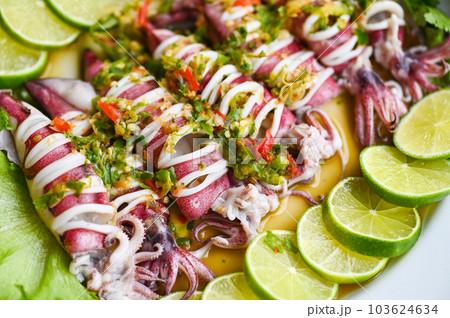 Steamed squid with lemon spicy chili and lemon sauce squid steamed with lime, Thai food seafood plate with herb and spices - top view 103624634